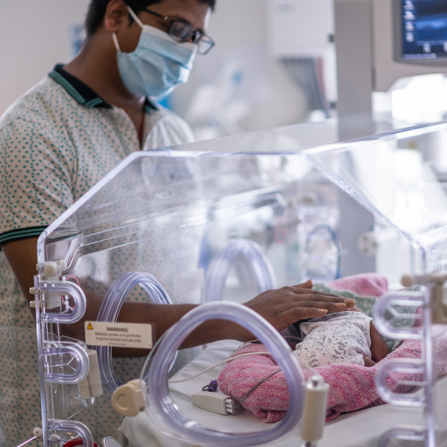 A father with his premature baby.