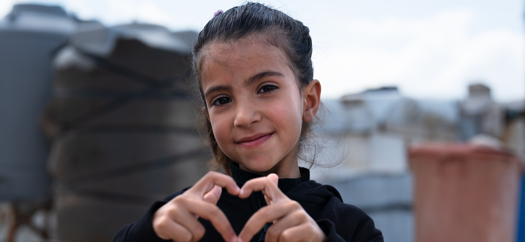 Emerat, 5, is in KG3 (Kindergarten 3). Syrian children pose for a photo at an informal tented settlement 
