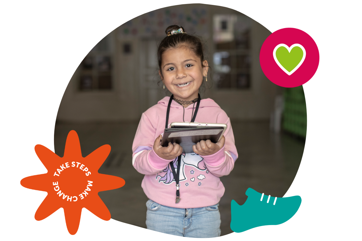 A child holding a tablet at an Early Years centre in Baalbek, Lebanon
